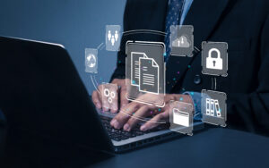 Businessman using computer to work with documents In modern computer document management system concepts Online document database and automated processes to manage files efficiently.
